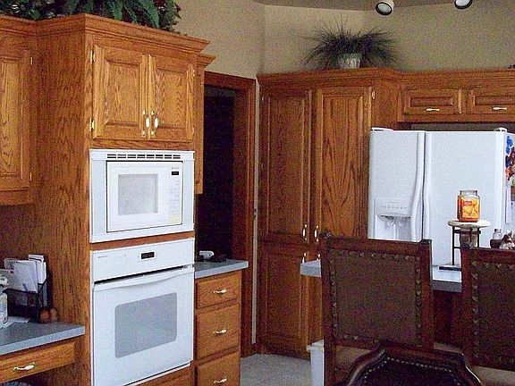 Kitchen has computer area and island.