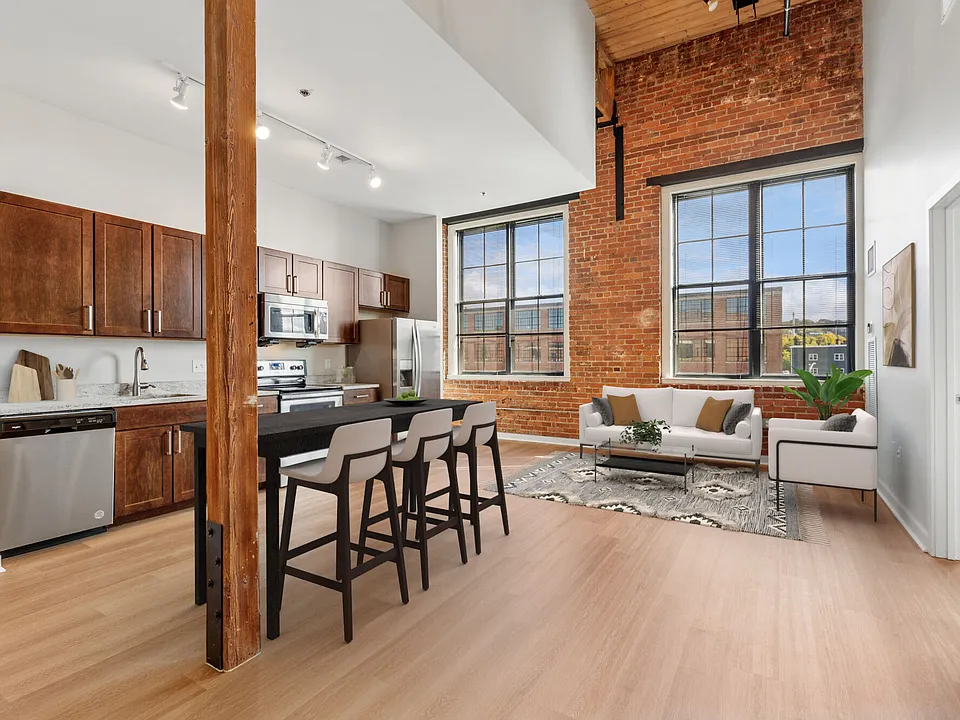 Open-concept loft apartment with high ceilings, oversized windows, and contemporary finishes