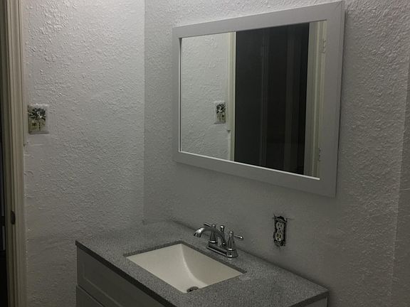 Beautifully renovated bathroom with bright LED lighting.
