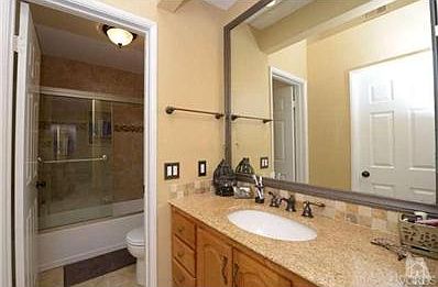 Bedroom suite offers granite counter and separate toilet and bath/shower combo for privacy