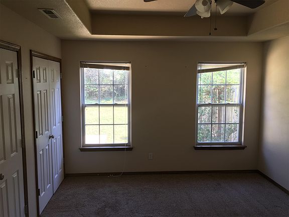 Two window with view to the fenced back yard