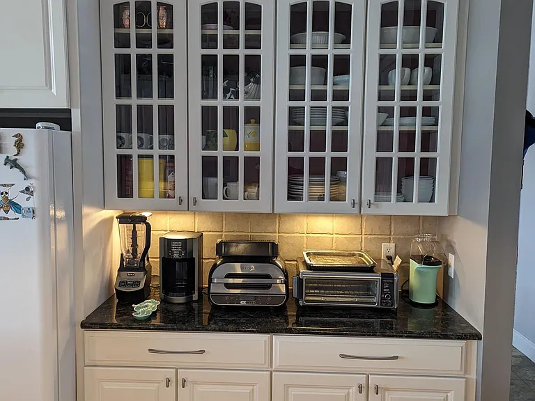 Kitchen bar. Appliances will include blenders, coffee makers, toaster oven, traditional toaster, air-fryer and plentiful cutlery, pots, pans and dishes. We will be leaving all kitchenware for your use.