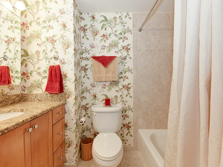 Spacious bathroom with ample counter and storage space.