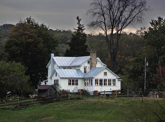 Looking Southwest
Evening zoomed photo from about a quarter mile away from the crest of the hill approaching on Wilt Store from the north. North Bedroom balcony door is photo center to left of old stone chimney.