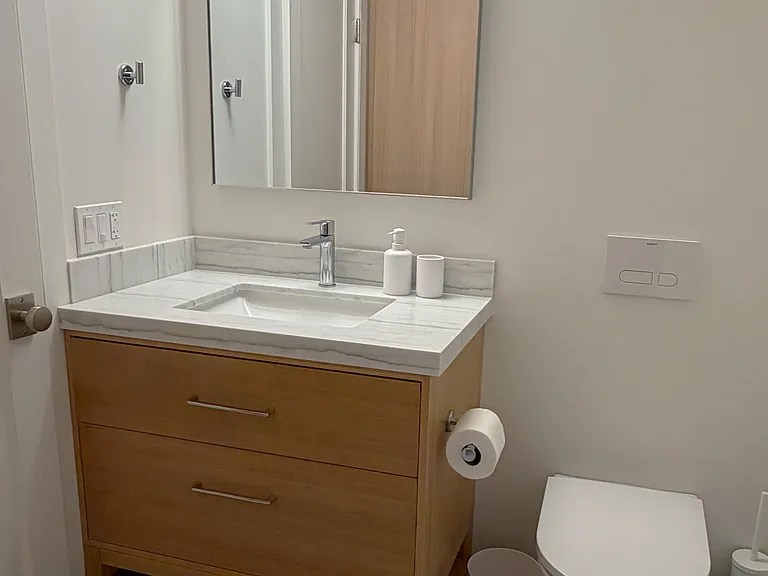 Bathroom Wider View (vanity has ample countertop and large drawers)