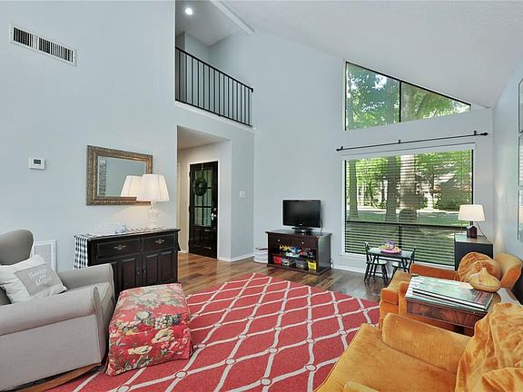 Soaring ceilings in the living room with large windows for an open light feel !