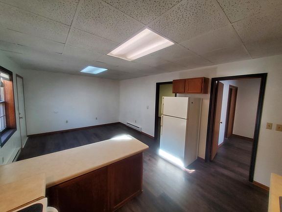 Kitchen, Common area. Bedroom doors on either side of refrigerator.
