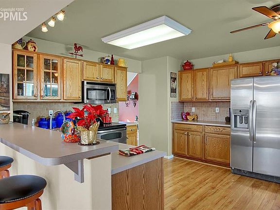 The large kitchen with all stainless steel appliances, wood flooring and a break