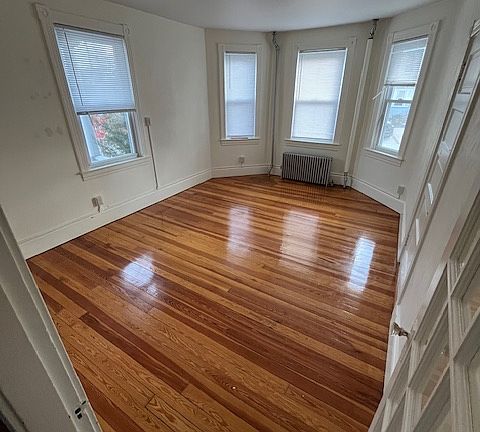 large living room with hardwood floors and bright natural lighting