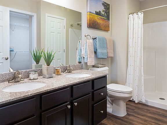 Granite Countertops & Sleek Cabinetry in Many Bathrooms
