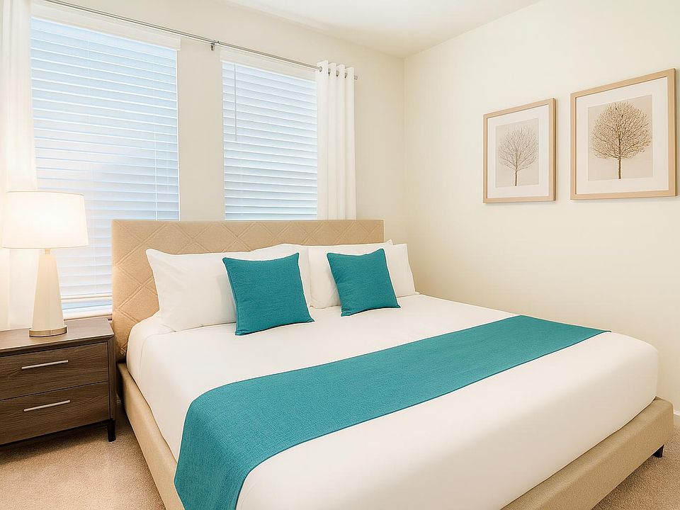 Inviting bedroom showcasing a bright, modern design with neutral tones complemented by teal accents.