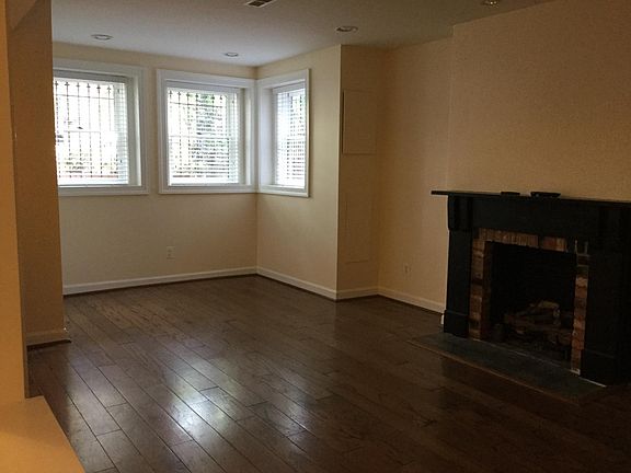 Sisable living room with bay window and gas fireplace. 