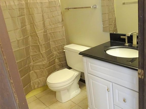 Clean bathroom with nice newer vanity and full tub/ shower combo.
