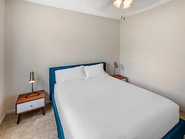 Furnished+ apartment homes feature queen bed with mattress, two pillows, dresser, nightstands, lamp, and mirror. (Representative Image exact items and style of furnishings may vary)