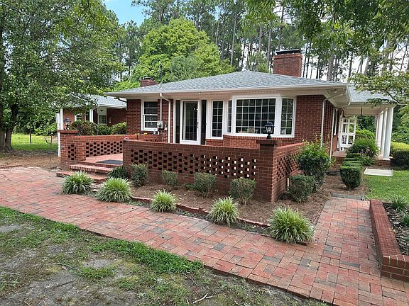 Brick side patio, generally the main entrance to the house. Please note landscaping is provided by the Owner