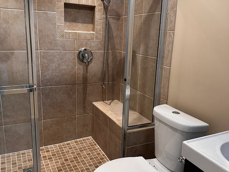 Basement bath shower with a built in seat