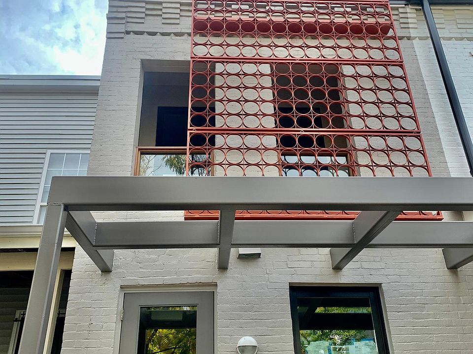 Front view. The front of the first floor and the smaller balcony on the second correspond to a different unit in the building. The entrance is shared.