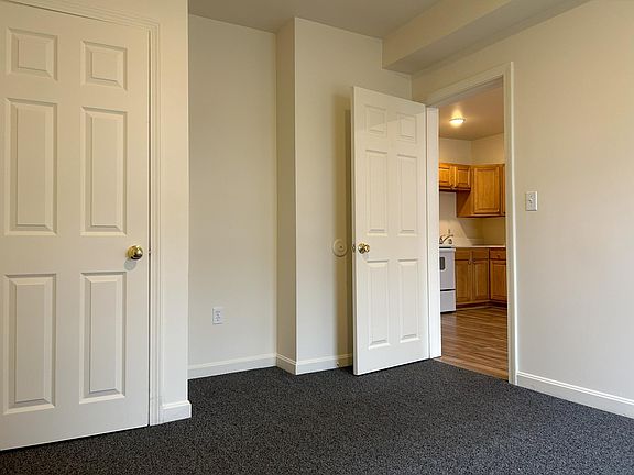 sunny bedroom with new carpet & closet