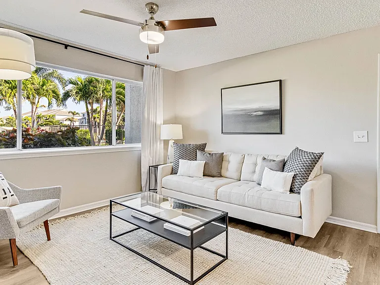 Spacious living area with connecting dining and kitchen areas.