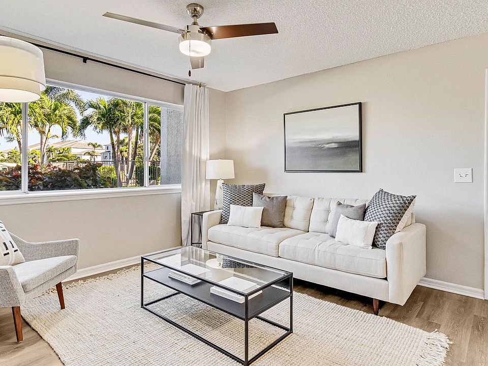 Spacious living area with connecting dining and kitchen areas.