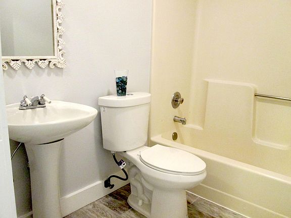 bathroom with newer decorator tiled flooring