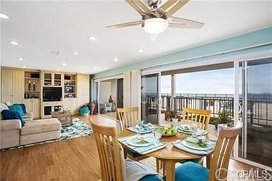 Living room/dining room combination with plank flooring, all enjoying the ocean views and breezes.