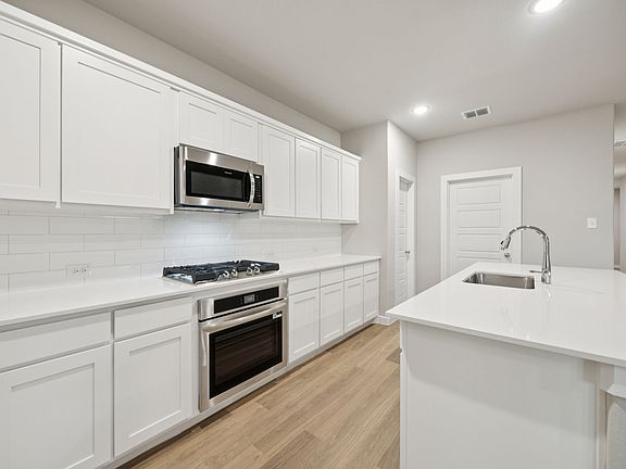 Kitchen in the Oscar home plan by Trophy Signature Homes - REPRESENTATIVE PHOTO