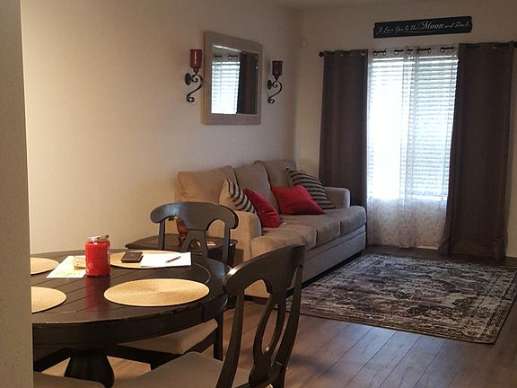 Dining and left side of living room with past tenant's furnishings (not included).