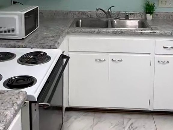 Remodeled spacious kitchen with dishwasher and refrigerator.