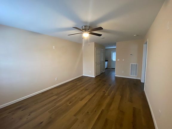 Living room looking toward the back where the kitchen and laundry room is located. Bedrooms and bathroom to the right.