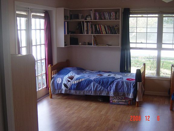 Gorgeous extra large room with laminate, french doors, and large windows.