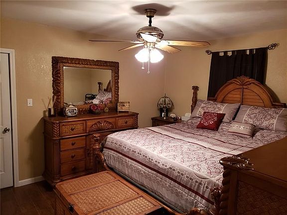 Master bedroom with laminate hardwood flooring.