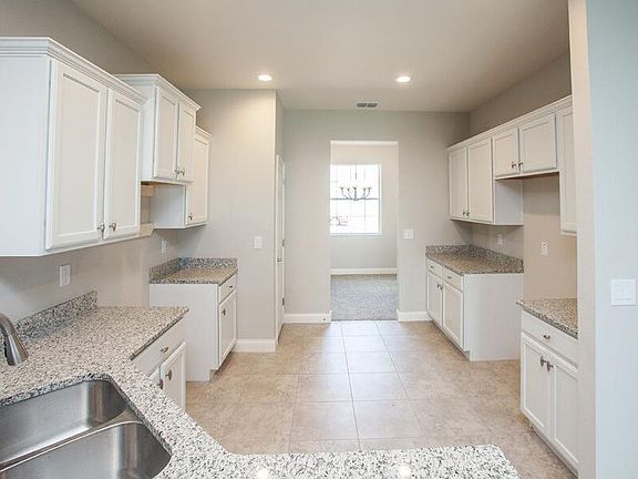 Luxurious, open kitchen with granite, 36-in. soft-close cabinets, and not pictured Samsung SS appl