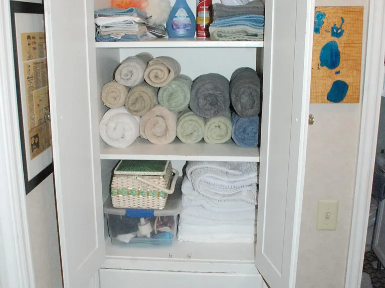 Hall linen closet holds 7 bath sheets (two below), 8 bath towels, sewing kit, first aid, with 3 drawers for sheets, etc. and room to spare. How will you fill the space?