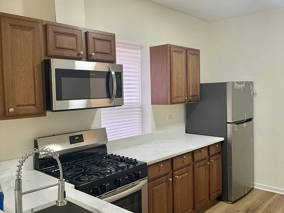Updated kitchen. Brand new marble countertops, modern sink and faucet, brand new fridge and appliances.