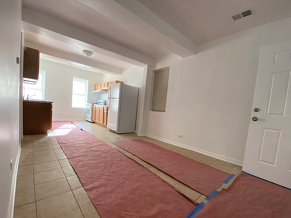 New tile flooring is protected by paper to keep it fresh and clean.