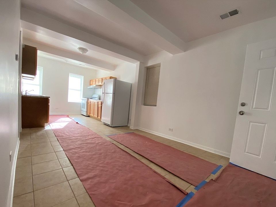 New tile flooring is protected by paper to keep it fresh and clean.