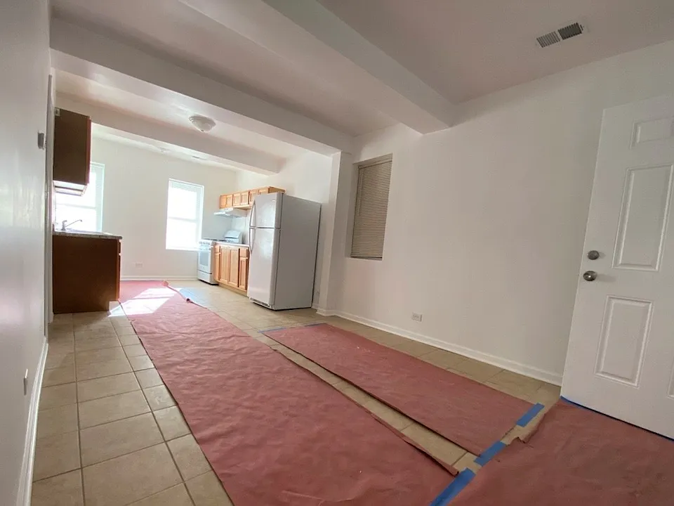 New tile flooring is protected by paper to keep it fresh and clean.