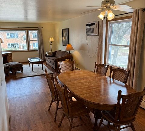 Dining room has ceiling fan, window, and table with seating for 6 (extra leaf in closet).