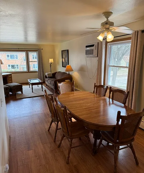 Dining room has ceiling fan, window, and table with seating for 6 (extra leaf in closet).