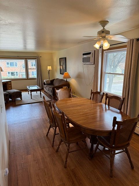 Dining room has ceiling fan, window, and table with seating for 6 (extra leaf in closet).