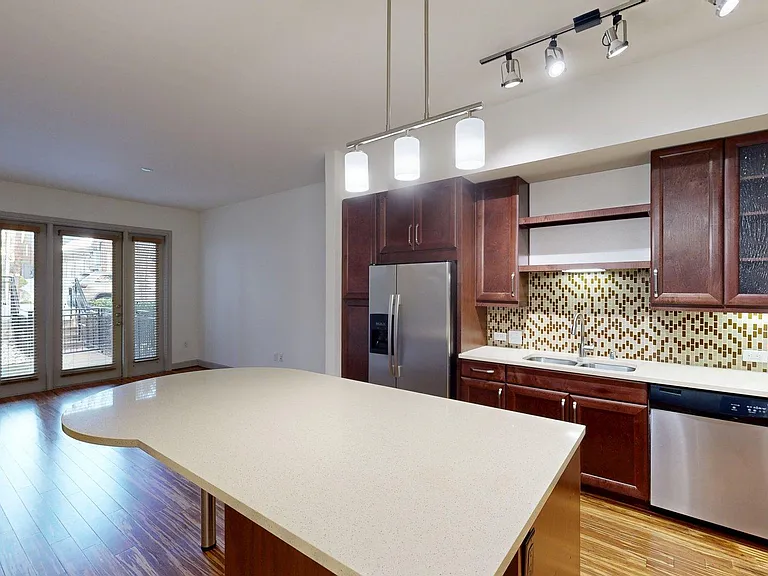 Apartment Kitchen with Stainless Steel Appliances, Dining and Living Room with Wood Style Flooring