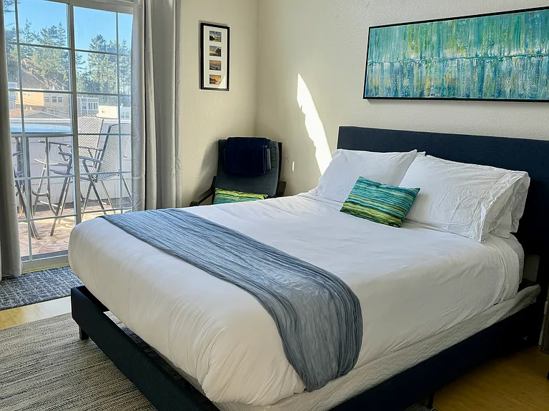 2nd bedroom with queen size bed and that opens out to balcony and sitting area to enjoy ocean and sunset views