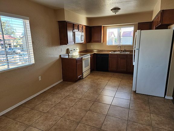 Kitchen with Tile Flooring, Glass Top Stove & Built In Microwave!