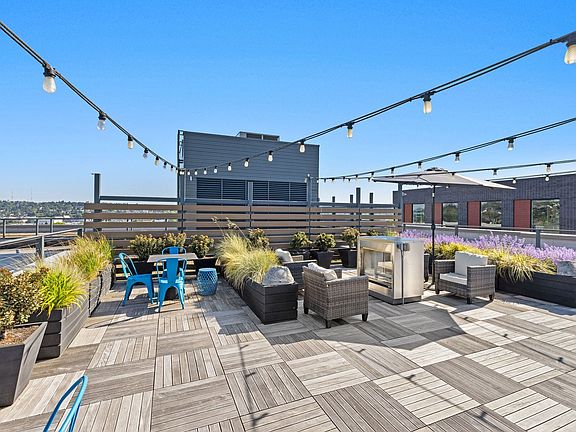Fire up the grill and dine under string lights with sweeping rooftop views