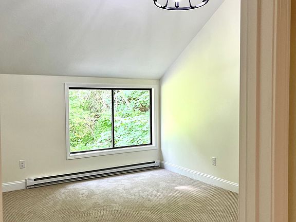 Bright and Sunny LARGE Main Bedroom with Vaulted Ceilings, Chandelier, and Staircase to Loft.