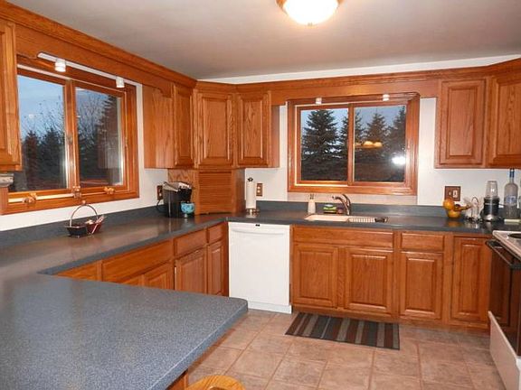 Kitchen offers newer cabinets plus solid surface countertops