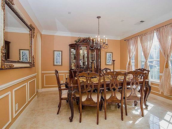 Elegant Formal Dining Area Features, Crown Millwork, Lovely Chandelier, Large Wall Of Windows! Excellent For Dinner Parties, Family Gatherings, Or Holiday Meals! This Home Has Lots Of Natural Light And Will Impress Your Guests.