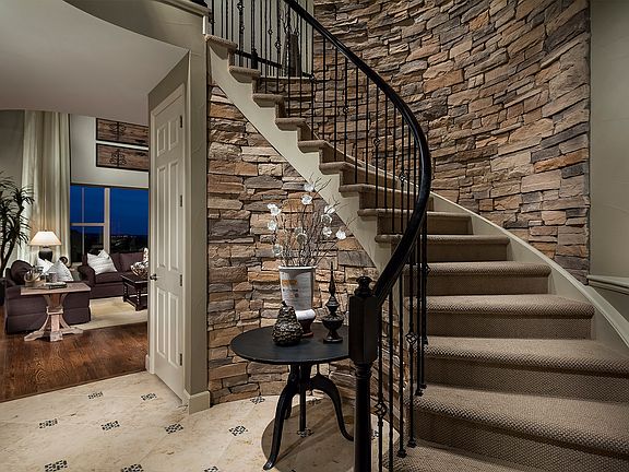 A sweeping staircase creates an entrance that will