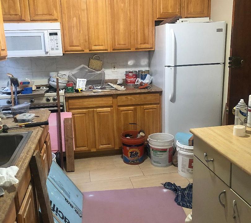 Finishing renovations for the kitchen with a large number of custom design wood cabinets for storage